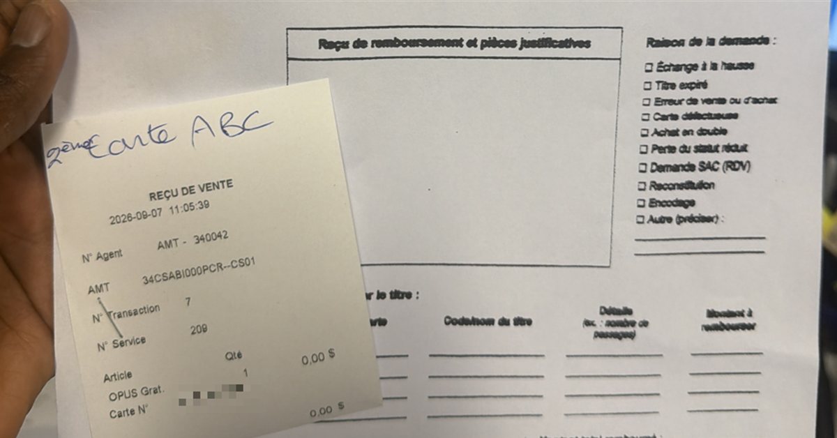 A sales receipt held by hand at an angle on top of a refund form